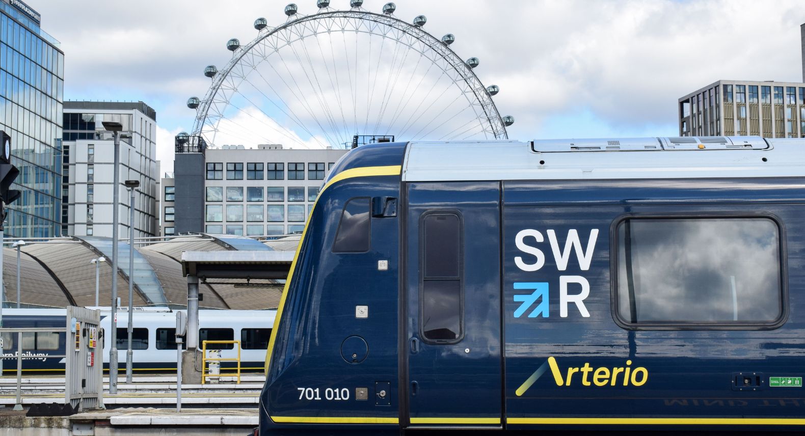 Sideview of Arterio train at Waterloo platform with the London Eye in the background