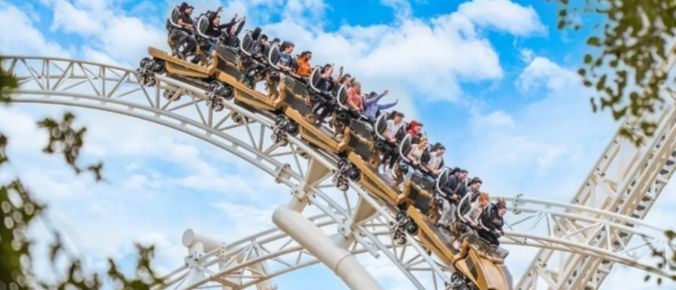 People enjoying a roller coaster ride - travel car free to sights and attractions with South Western Railway
