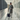 Business traveller walking through a modern airport corridor with suitcase and passport.