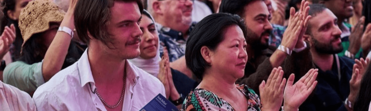 Festival audience clapping during comedy show