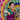 Dancer in vibrant sari performing traditional Indian dance against a colourful “Mela” festival backdrop
