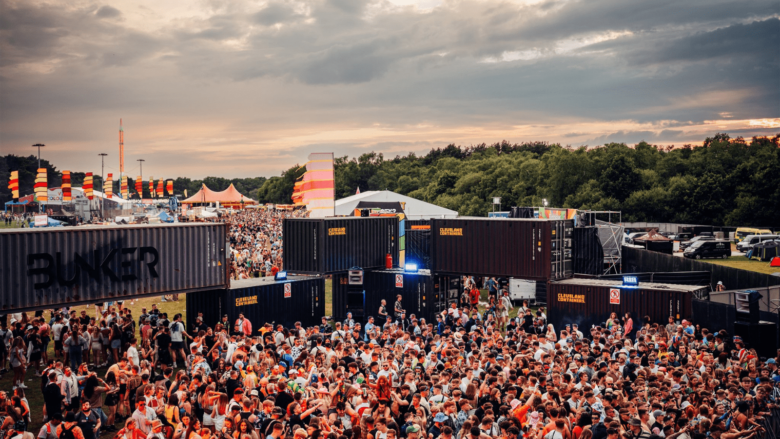 Crowds of people dancing outside at a festival