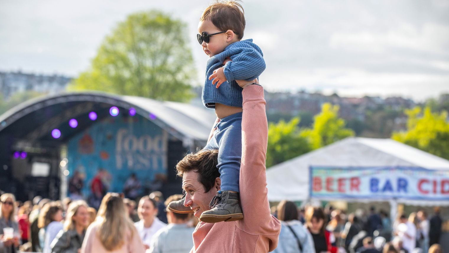 father holding a baby above his head