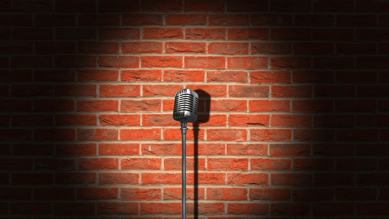 A microphone in front of a brick wall 