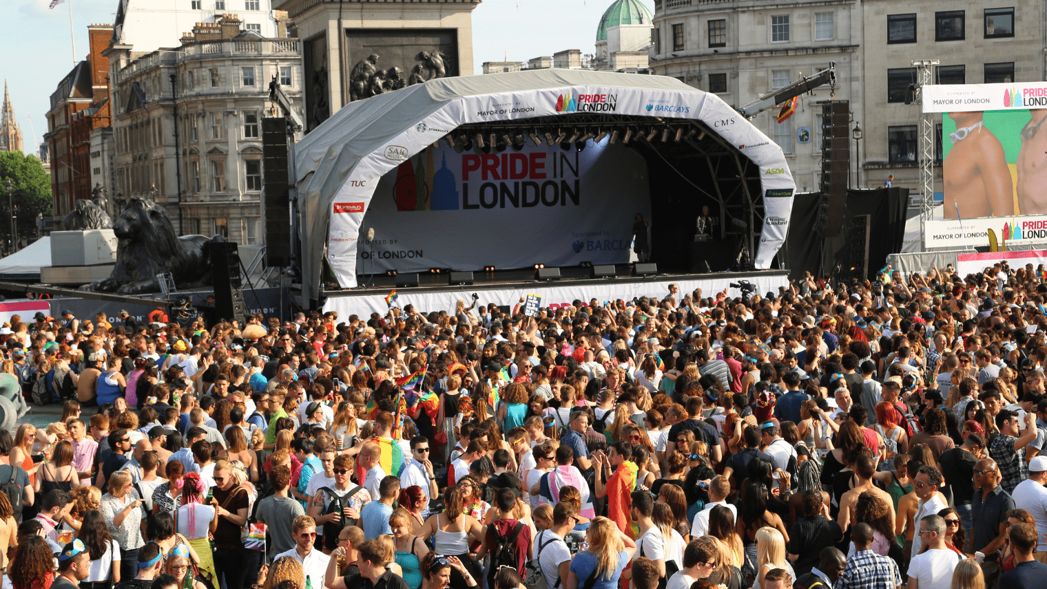 Image of a London Pride concert with a crowd looking towards a stage