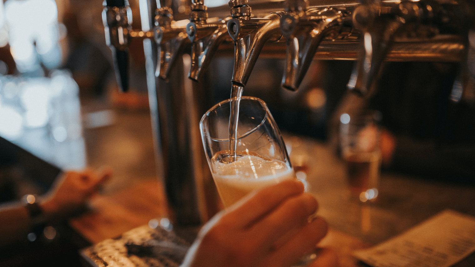 Image of a person pouring a pint at a pub