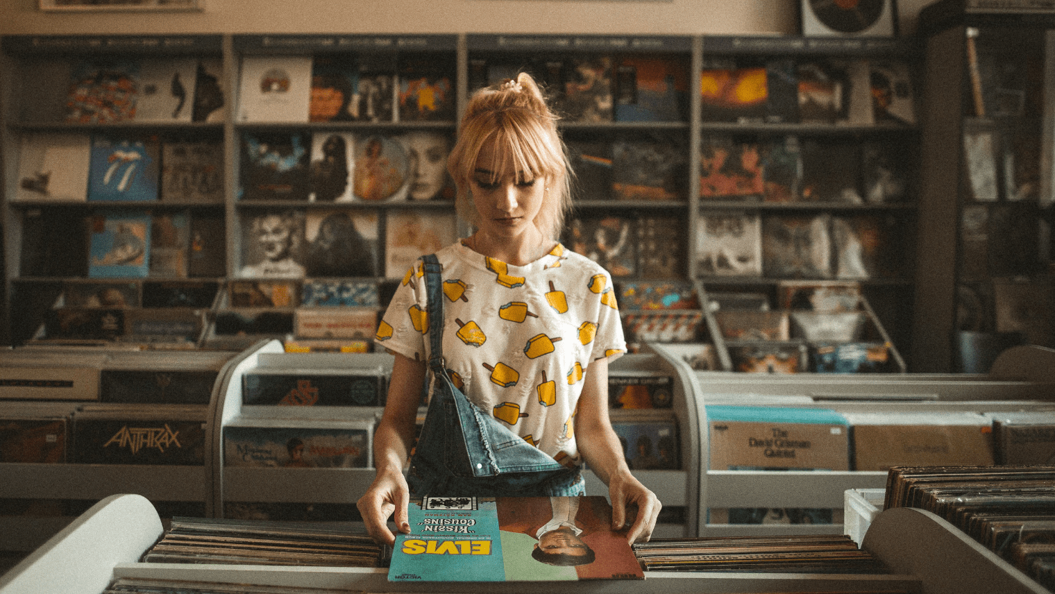 An image of a person looking at records at a record store