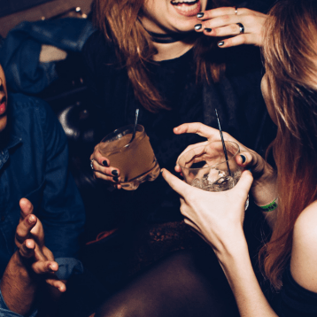 2 women with drinks in their hands