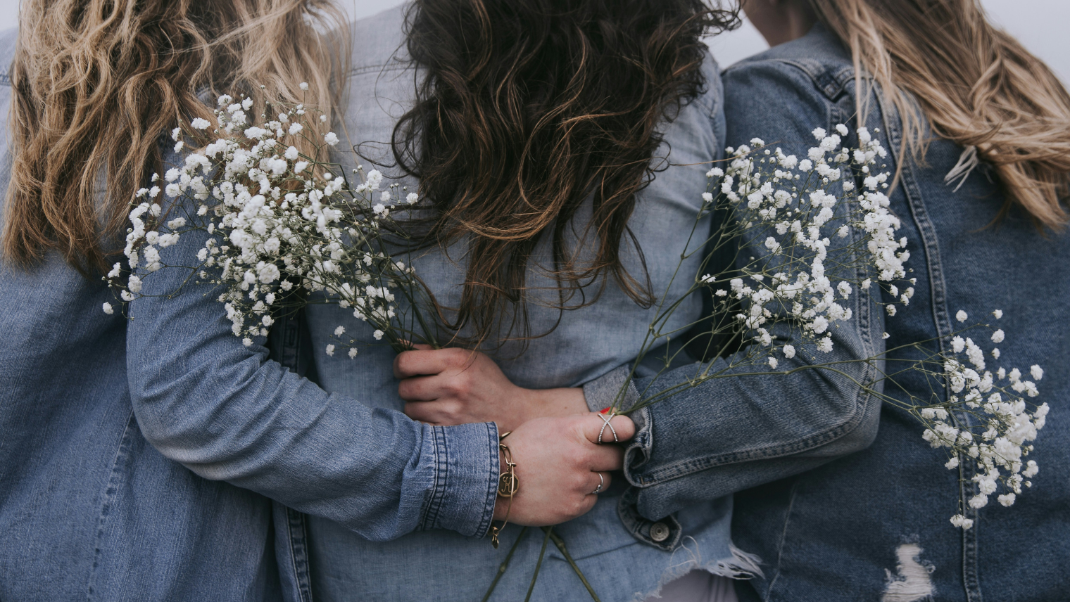 3 women linking arms