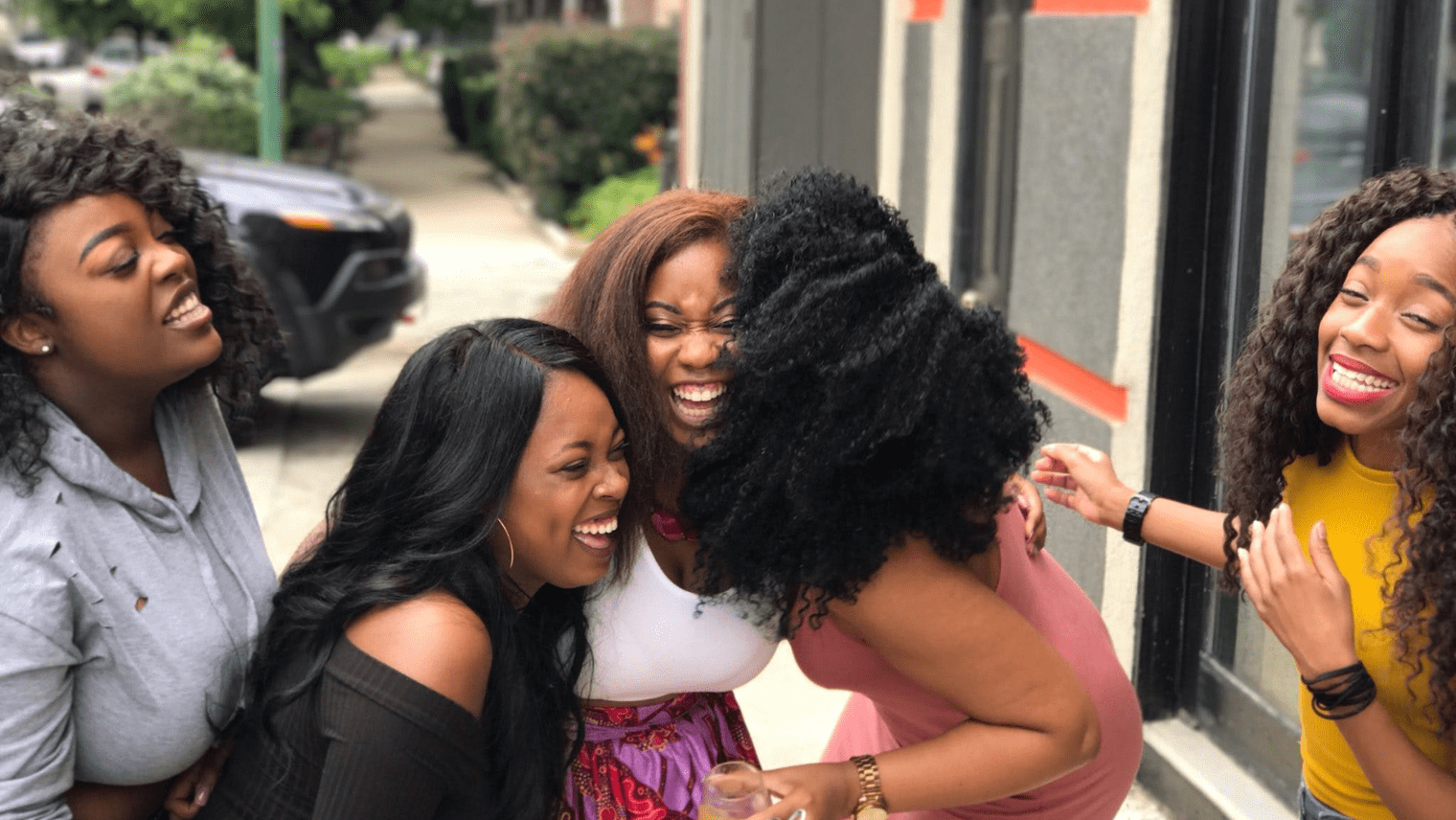 5 women laughing together