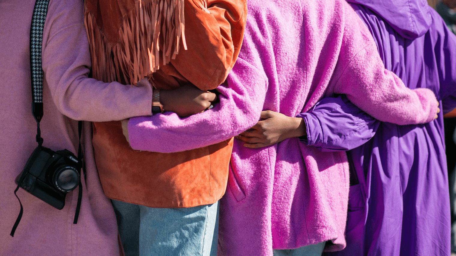 A group of women linking arms