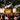 Crowd watching a football match on a big outdoor screen at a fan zone.